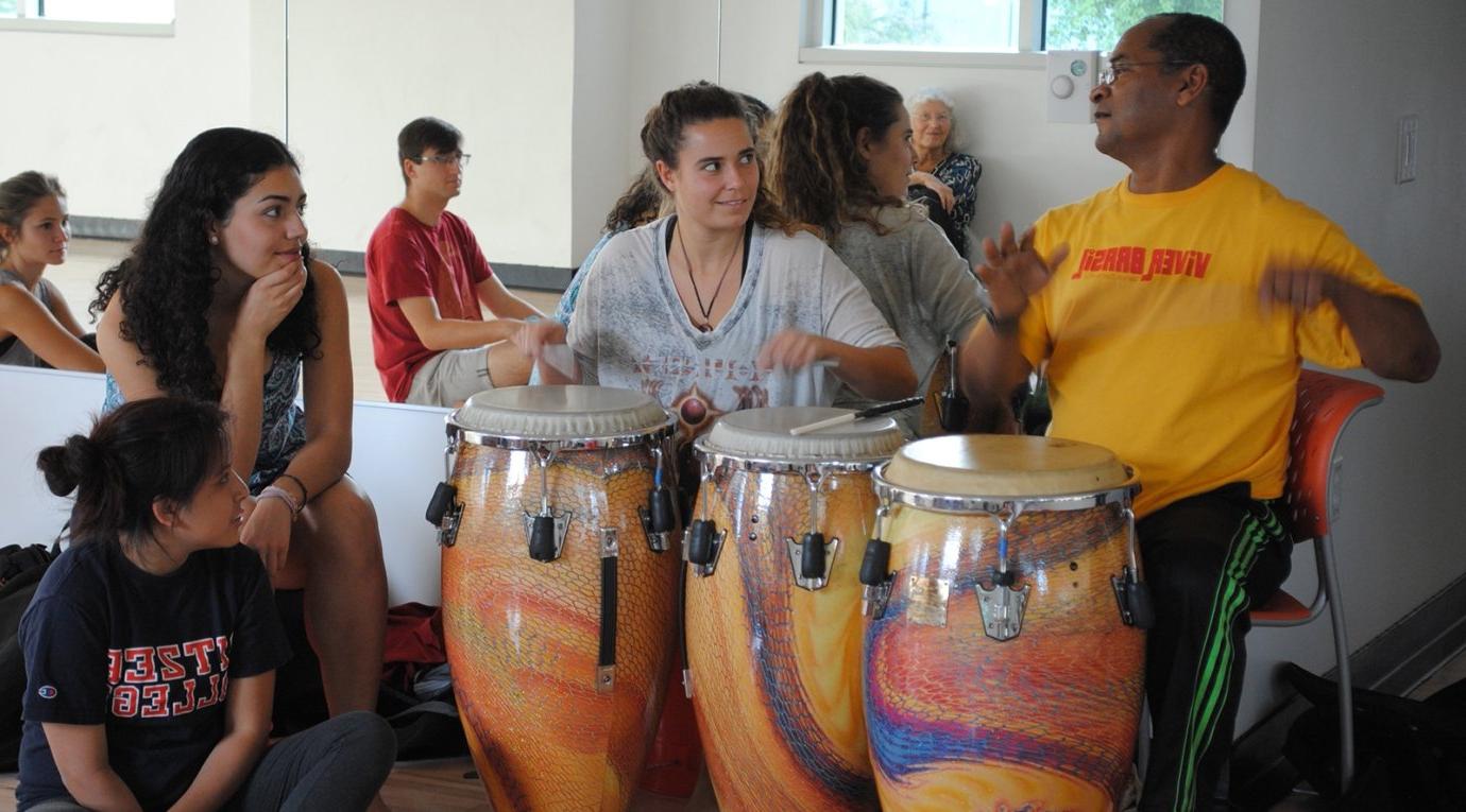 students learn how to play bongos